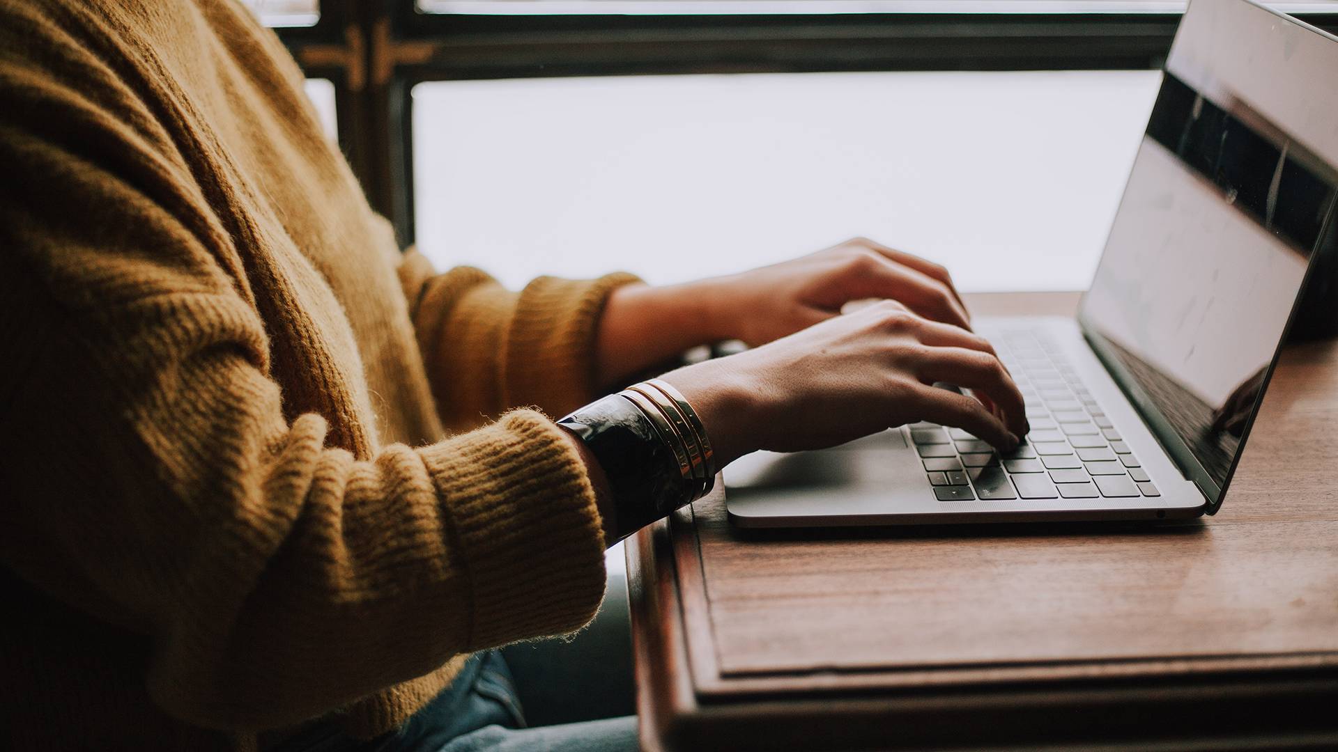 A person typing on a laptop