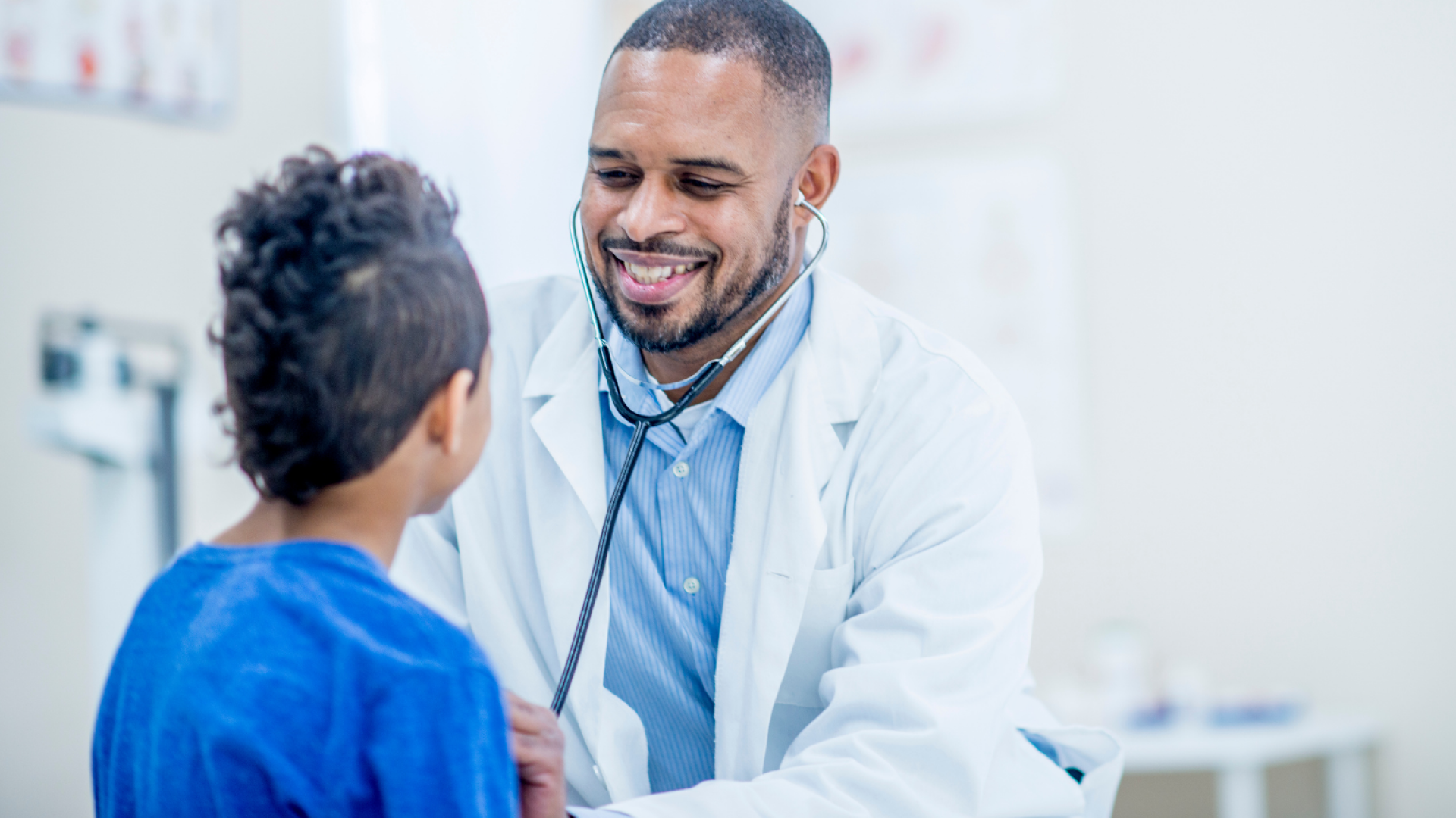 A friendly doctor consults with a seated patient.