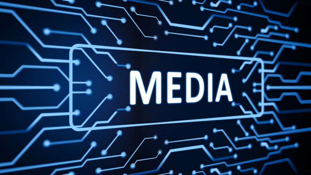"Digital circuit board design with glowing blue lines forming pathways and nodes, overlaid with the word 'MEDIA' in bright white letters, representing technology-driven media and data networks."