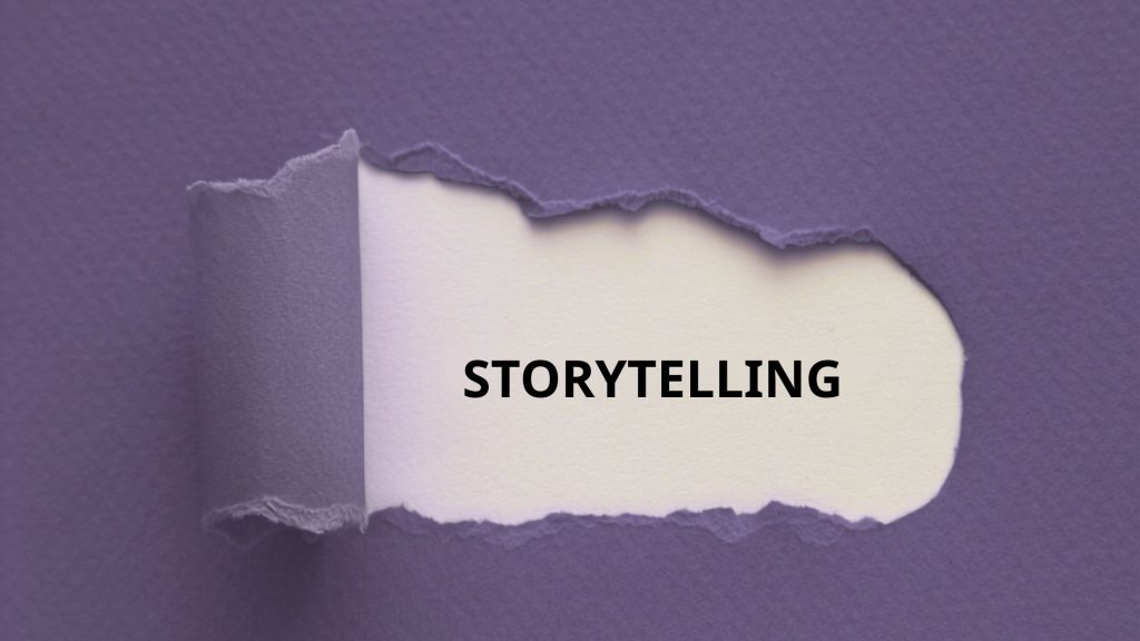 Detail of a purple notebook cover with a section torn to reveal the word "storytelling" on the first page
