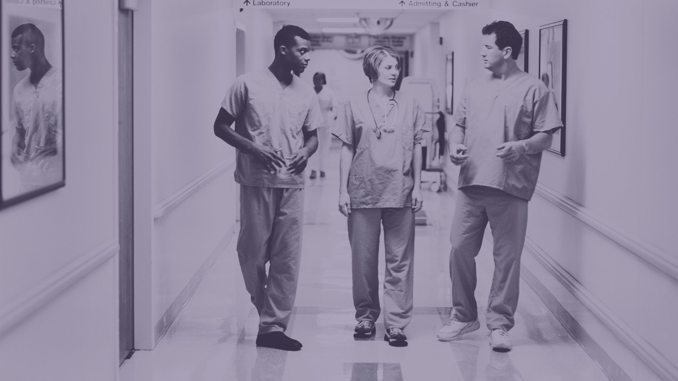 hospital workers walking down a hall and conversing