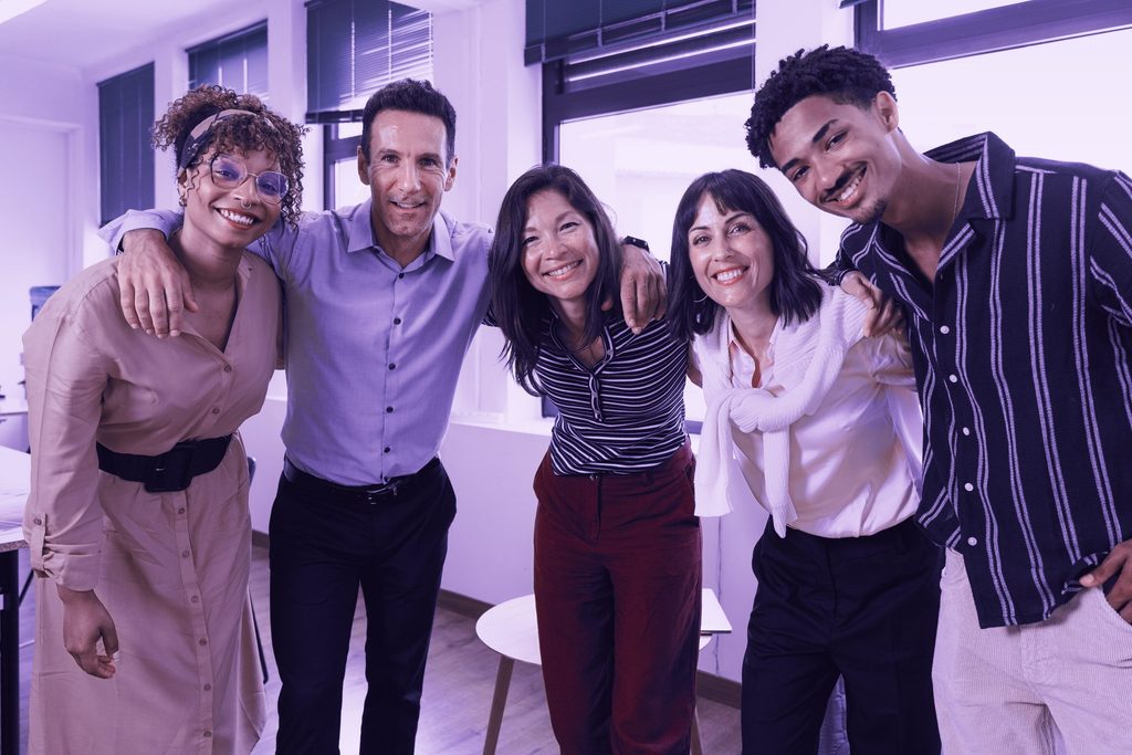 Startup business team smiling and embracing in modern office